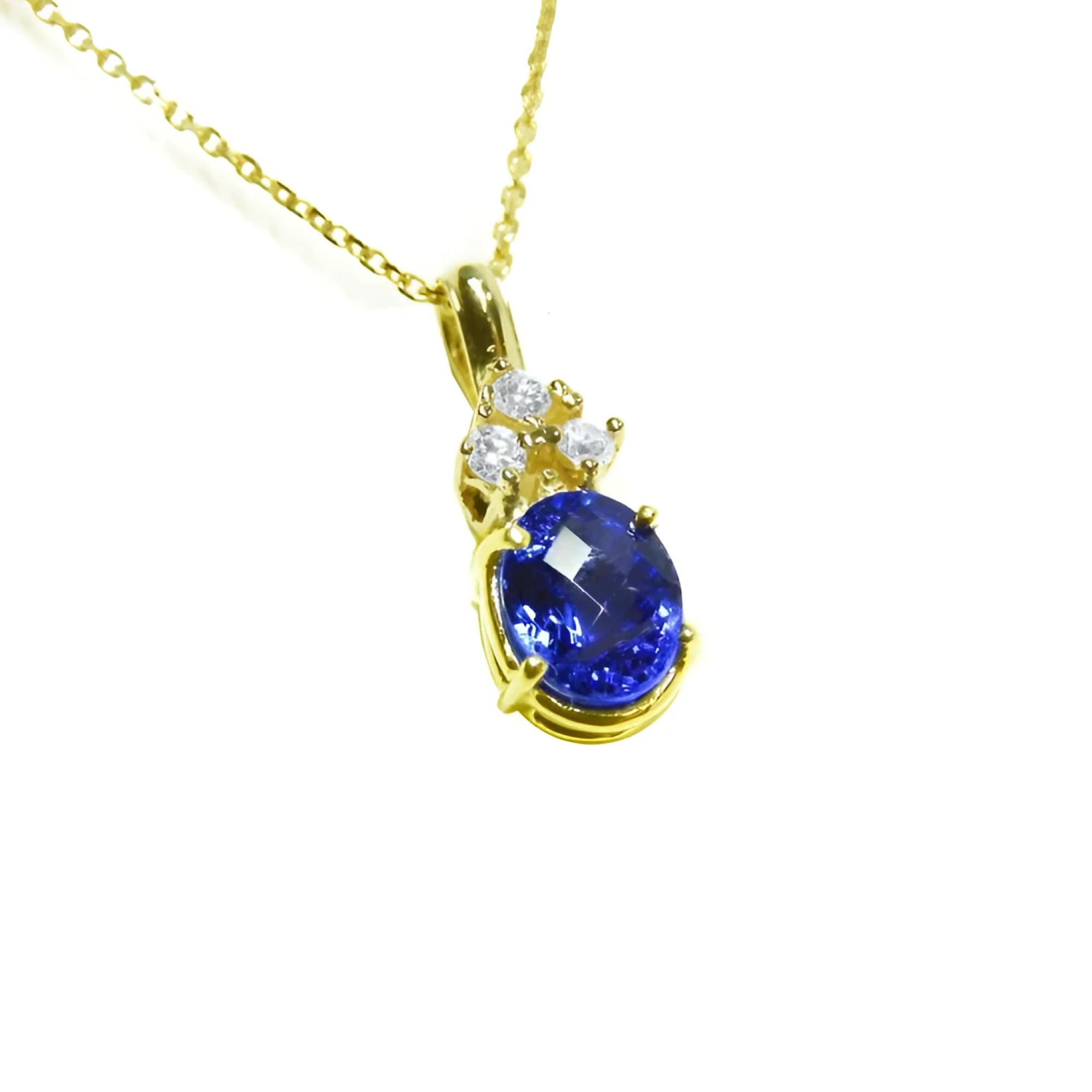 14K yellow gold pendant with oval tanzanite and three round diamonds on a delicate chain.