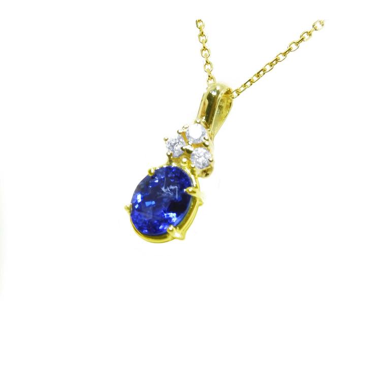 14K yellow gold pendant with oval tanzanite and three round diamonds.
