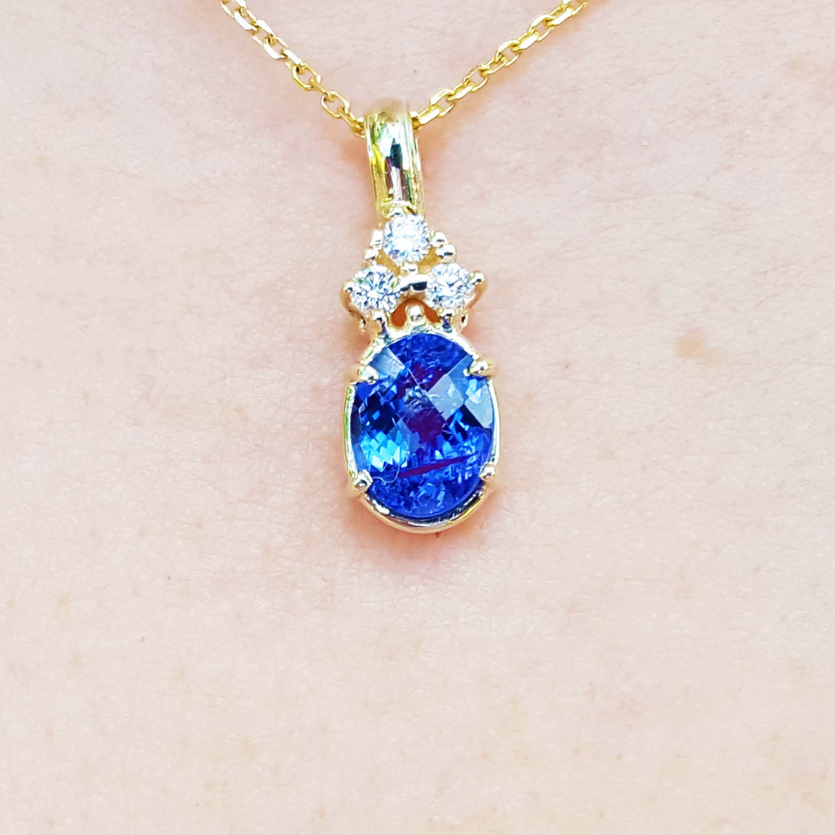 Natural tanzanite and diamond gold pendant oval briolette cut made of 14k yellow gold.