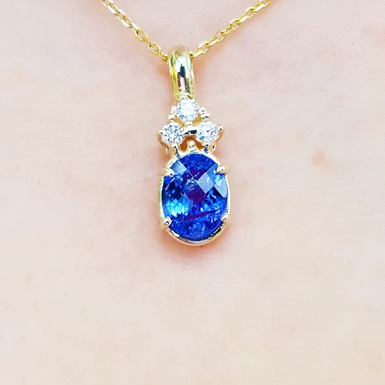 1.48 ct. natural tanzanite pendant with diamonds in 14K yellow gold.