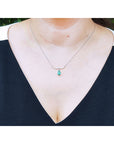 Mother's Day gift necklace natural Colombian emerald dangling from a wavy central bar with diamonds pave set in 14k white gold