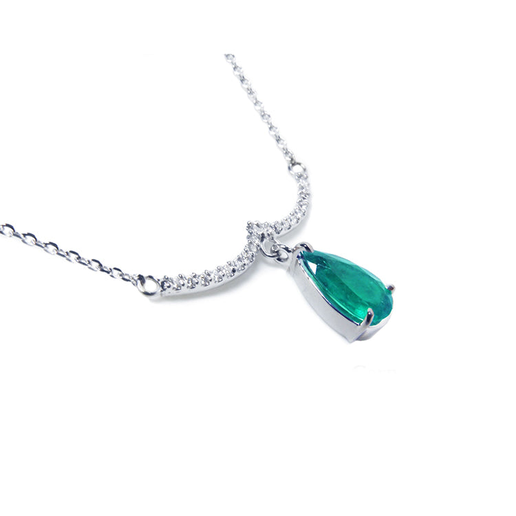 Emerald necklace natural Colombian emerald dangling from a wavy central bar with diamonds pave set in 14k white gold