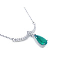 Emerald necklace natural Colombian emerald dangling from a wavy central bar with diamonds pave set in 14k white gold