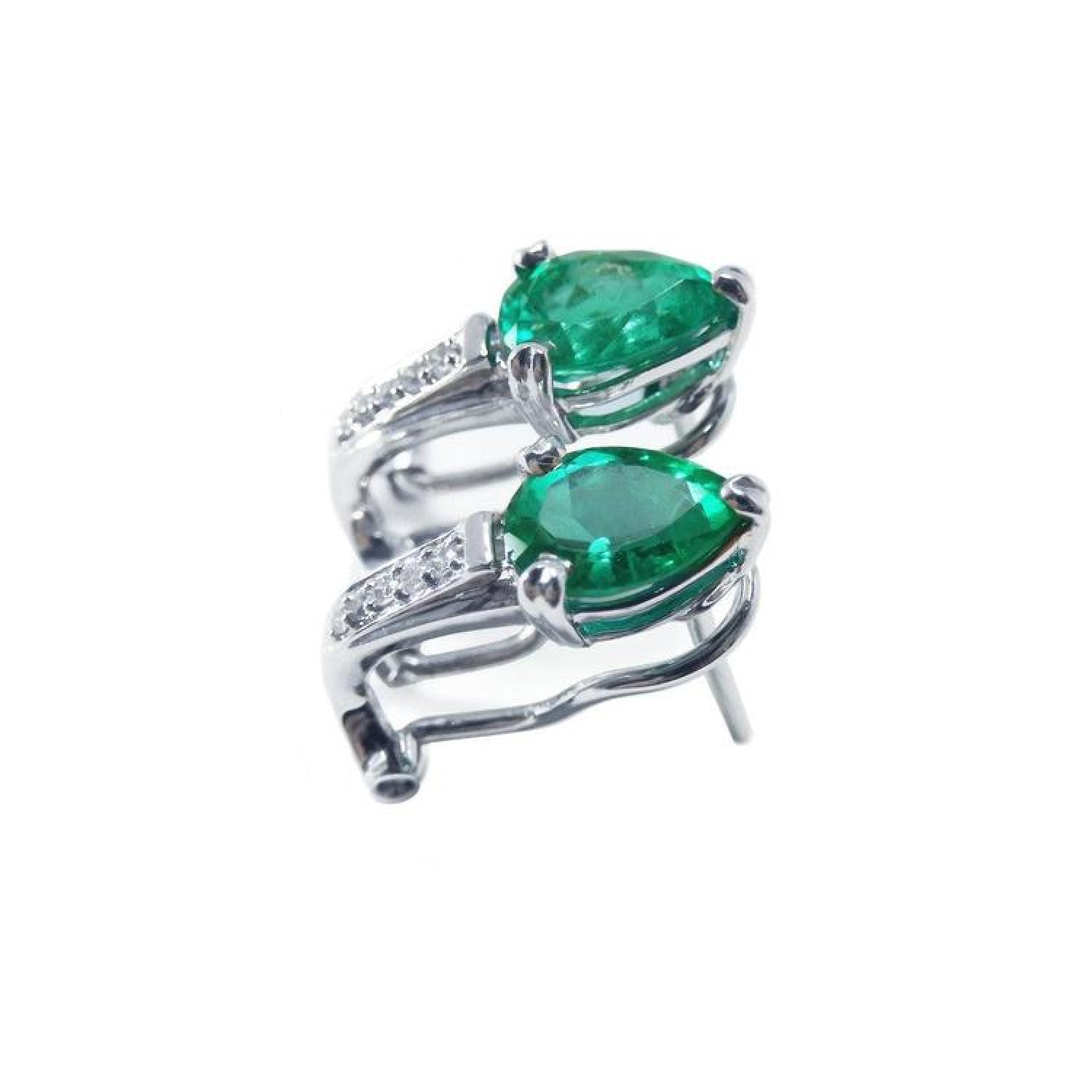 Pair of pear-shaped emerald clip-on earrings with diamond accents in 14K white gold.