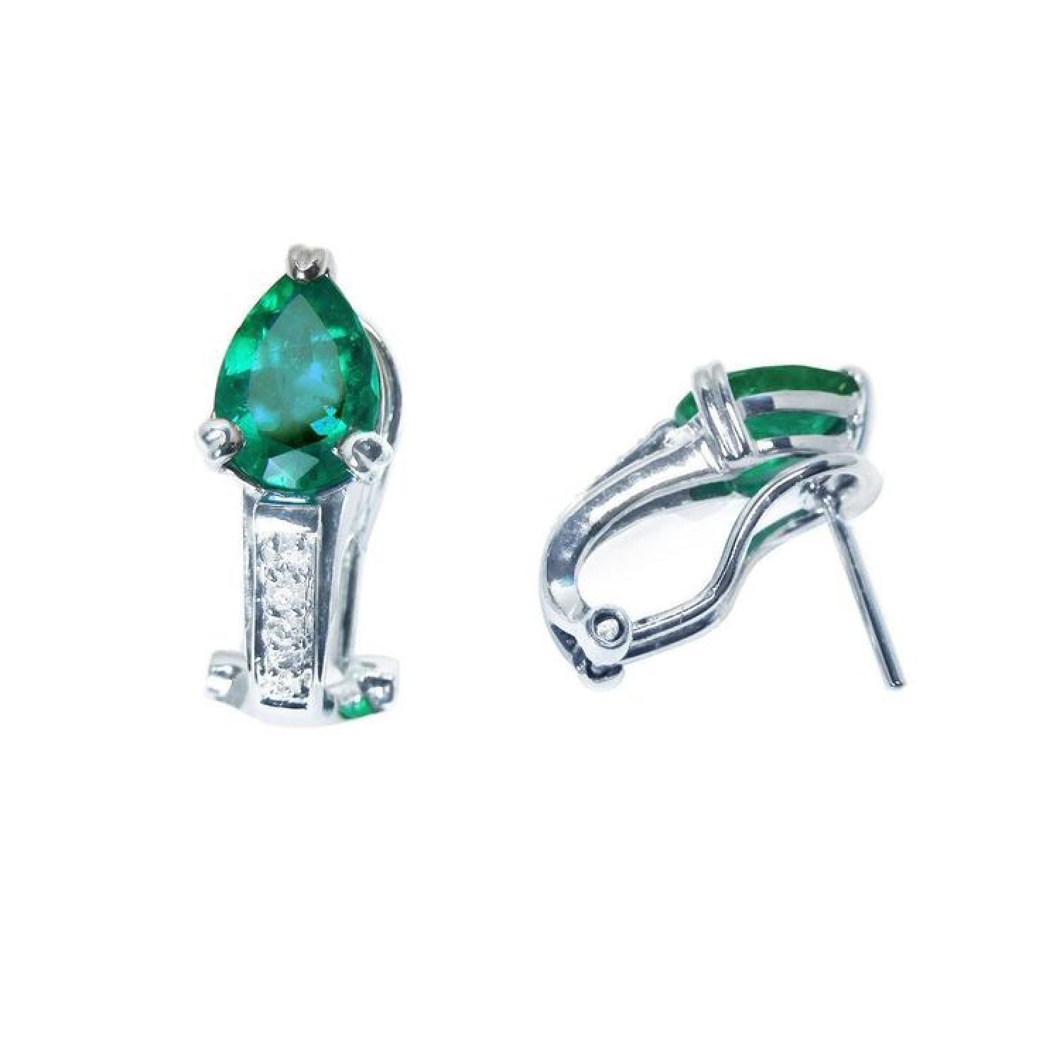 14K white gold clip-on earrings with pear-shaped emeralds and accent diamonds.