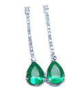 White gold emerald dangle earrings
