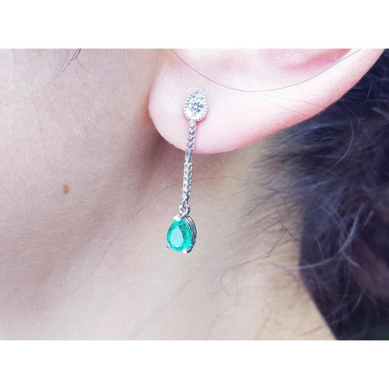 Emerald dangle earrings with pear-shaped Muzo emeralds and diamonds in 14K white gold.