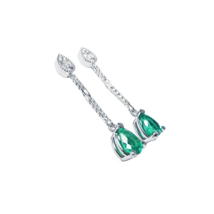 Pear-shaped emerald dangle earrings in 14K white gold with diamond accents.