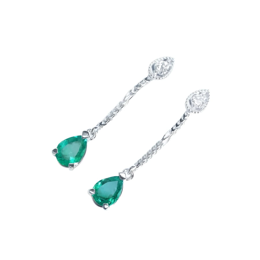 Pear-shaped Muzo Colombian emerald dangle earrings in 14K white gold with diamond accents.
