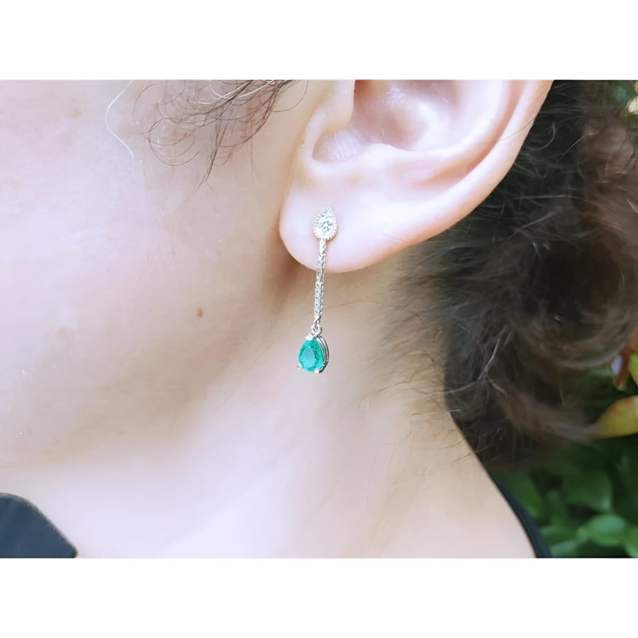 Emerald dangle earrings with pear-shaped Muzo emeralds and diamonds in 14K white gold.