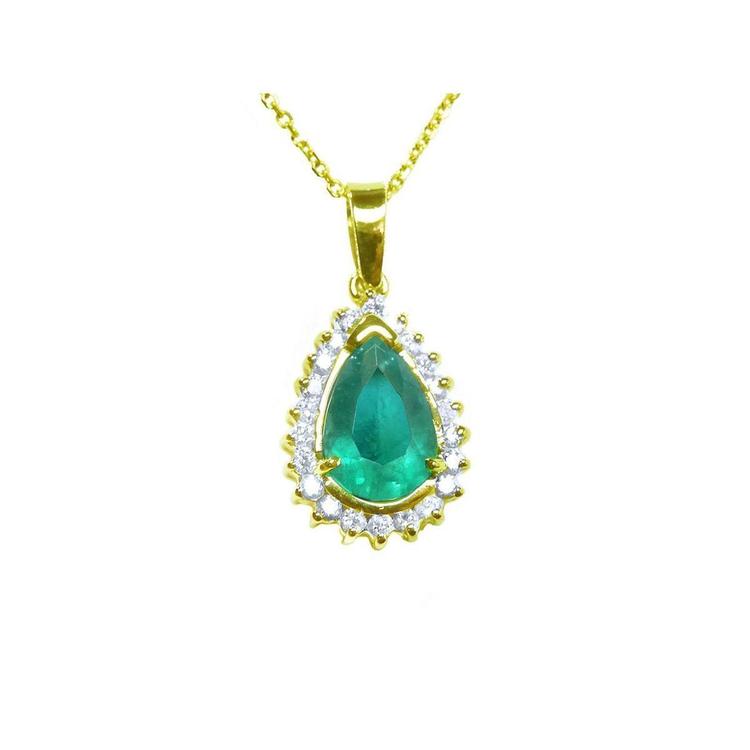 The topside view of a teardrop natural colombian emerald pendant encircled by a halo of natural diamonds in yellow gold.
