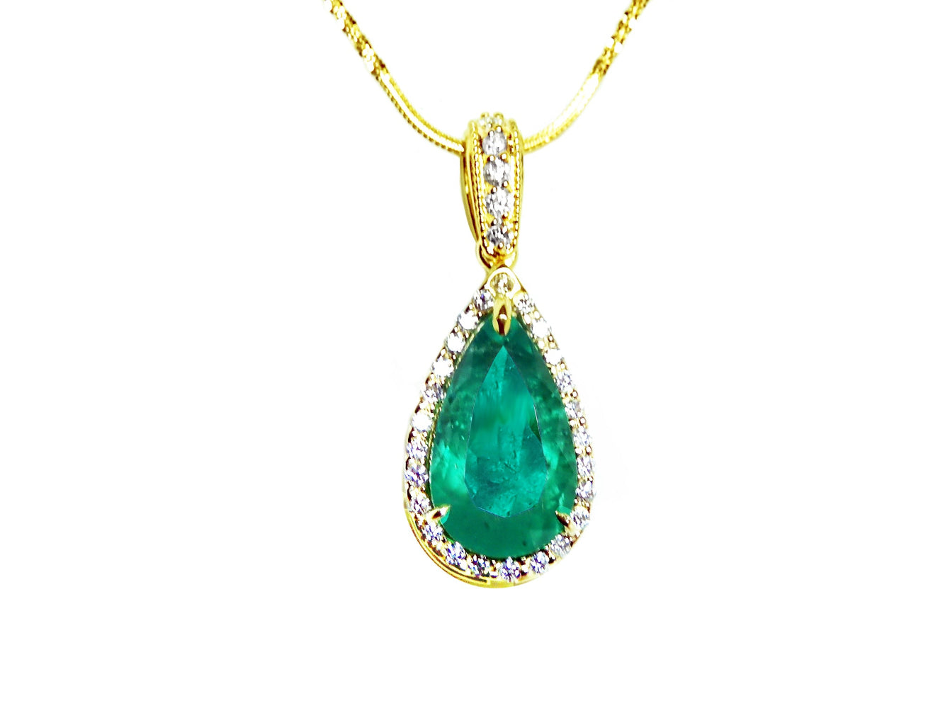 Teardrop-shaped emerald pendant on a gold chain topside profile view against a white background