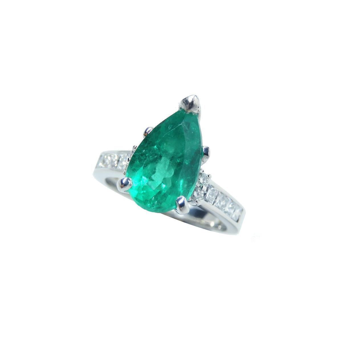 Ring with a natural Colombian teardrop emerald and diamond accents on a white background.