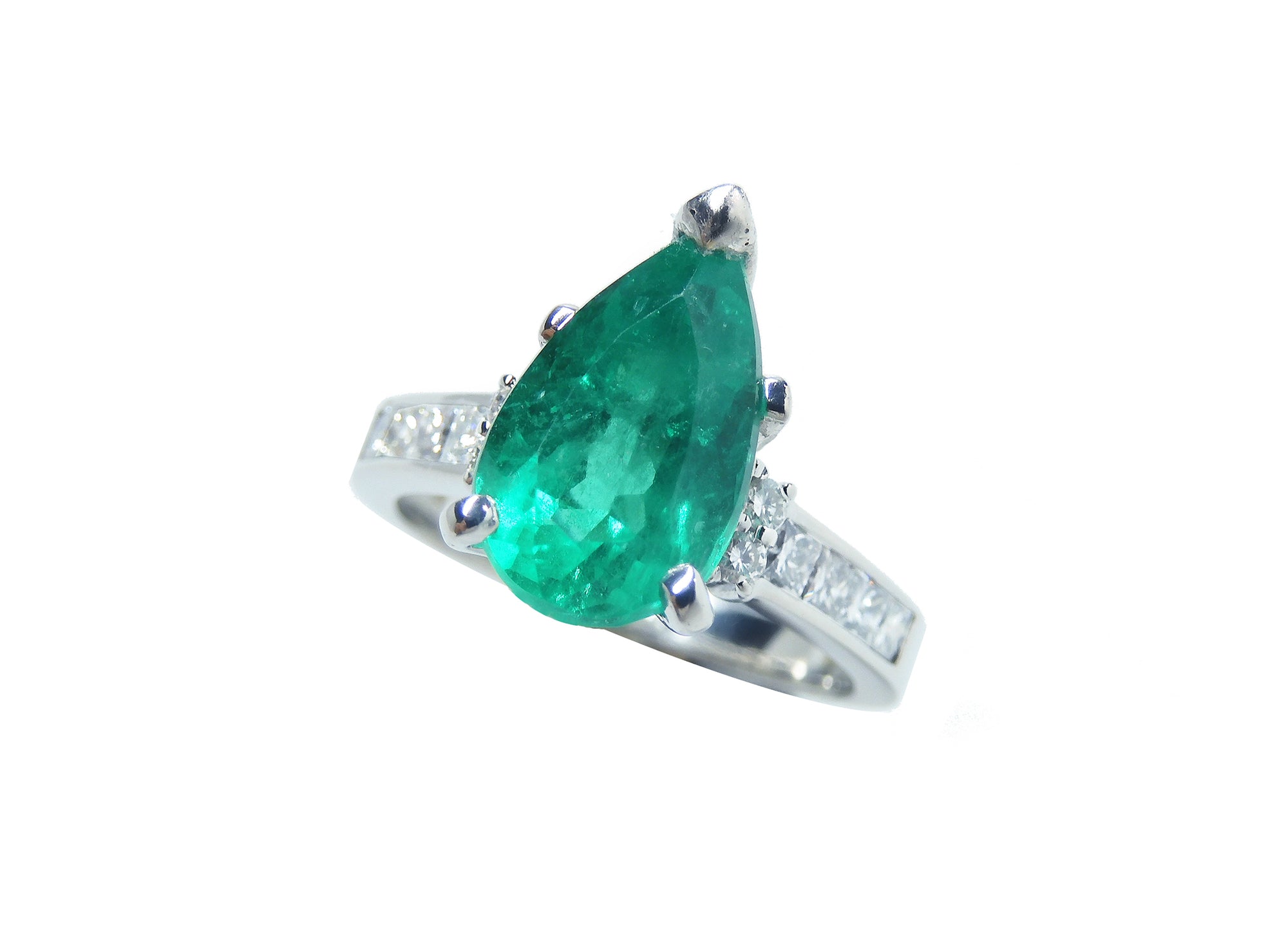 Ring with a natural Colombian teardrop emerald and diamond accents on a white background.