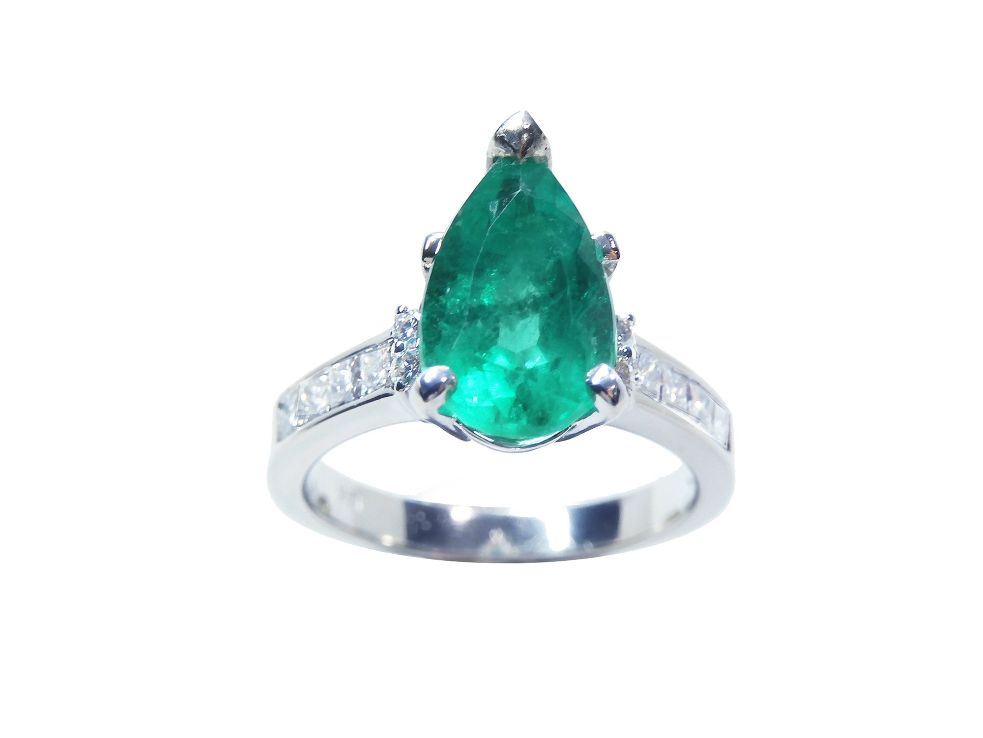 A topside view of a teardrop emerald ring white gold with accent diamonds.