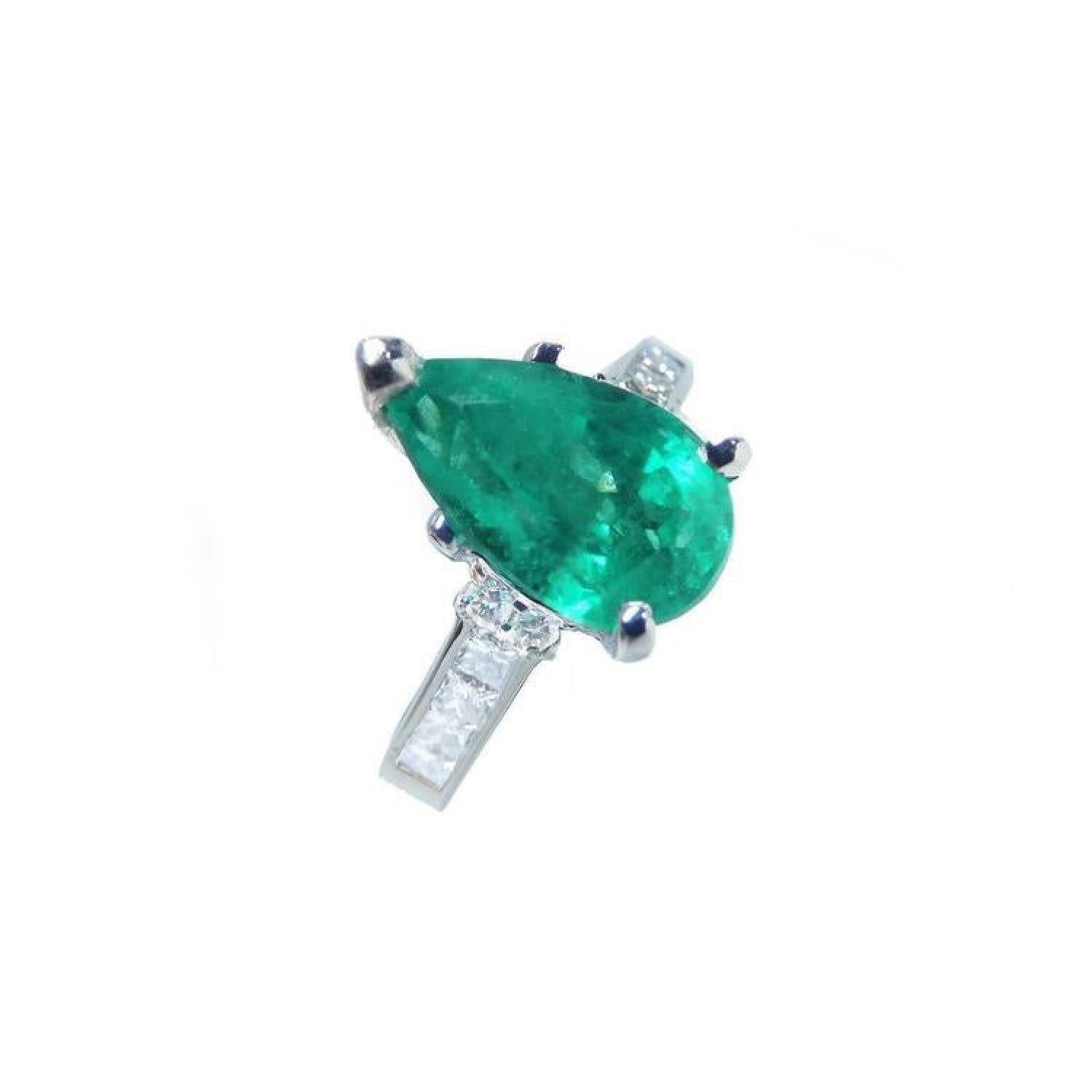 3.09 ct pear-shaped deep bluish-green emerald ring with princess-cut diamonds in 14K white gold.