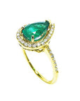 A yellow gold emerald ring with the top and band on side profile position.