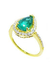 This 14k yellow gold teardrop emerald and halo diamond ring displays the top and band profile.