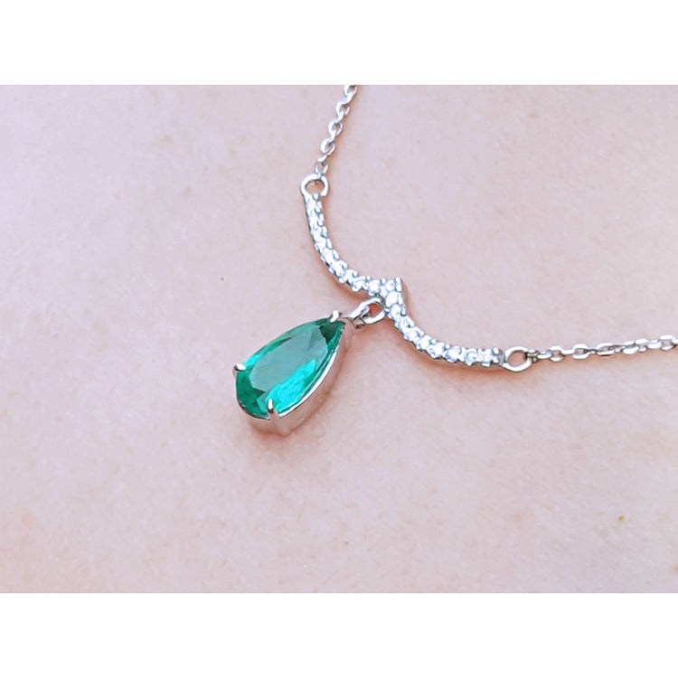 USA made women&#39;s necklace natural Colombian emerald dangling from a wavy central bar with diamonds pave set in 14k white gold