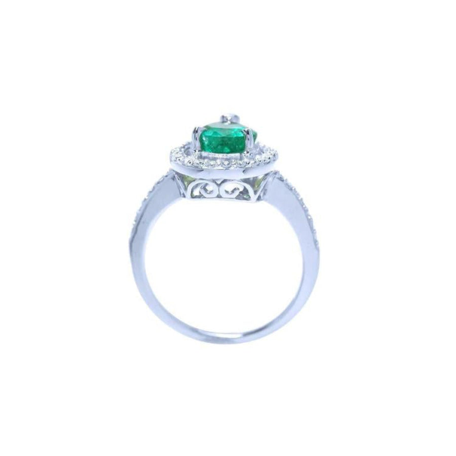 14K white gold teardrop halo ring with a vibrant green emerald and diamond accents.