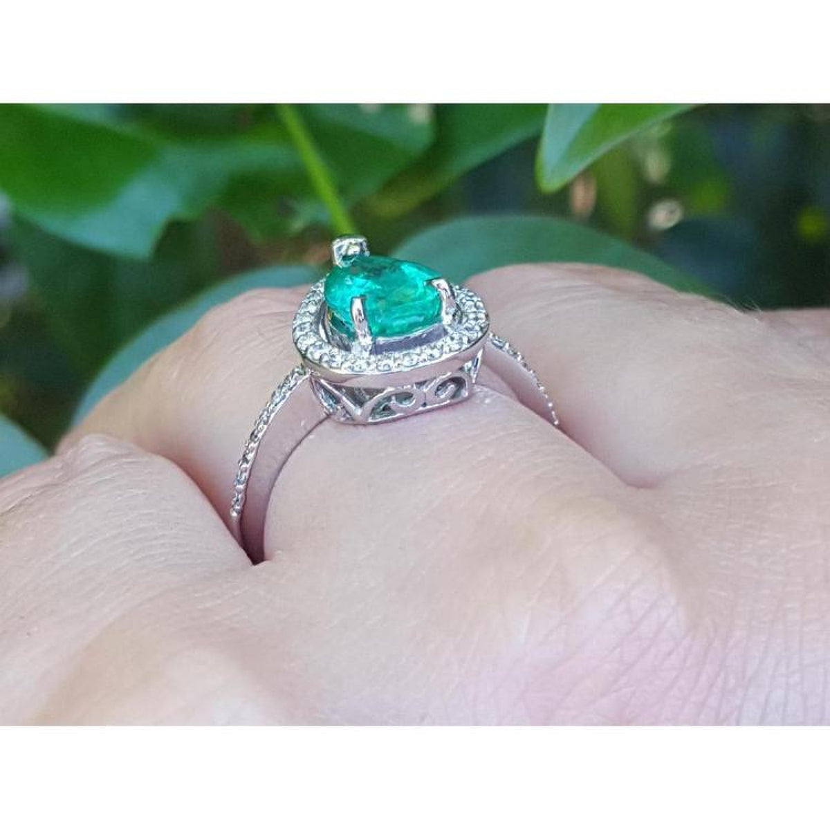 1.39 ct. teardrop emerald halo ring in 14K white gold with natural diamonds.