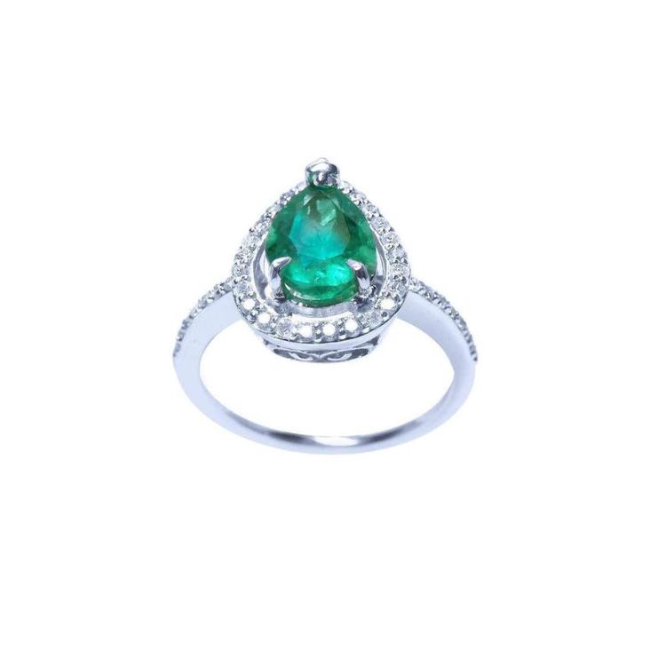 A teardrop natural emerald encircled in a halo diamond crafted in white gold topside view.