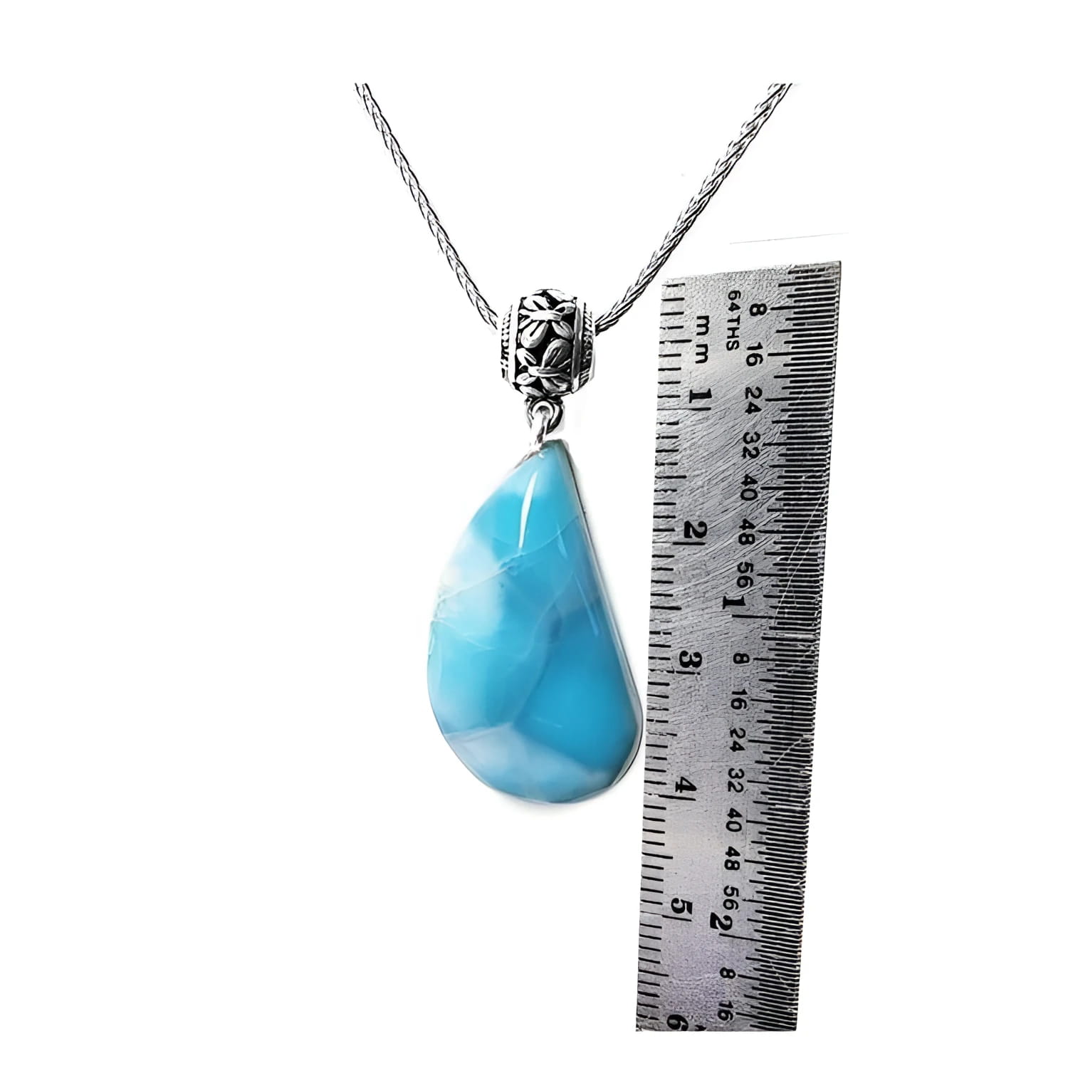 Vivid blue and white teardrop larimar pendant on a sterling silver necklace, next to a ruler.