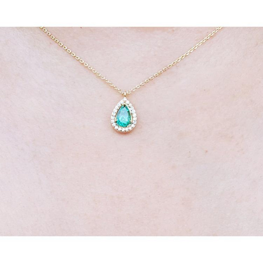 Pear-shaped natural emerald necklace with diamond halo on a 14K yellow gold chain.