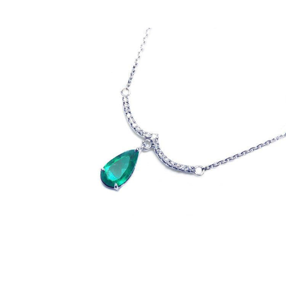 14K white gold necklace with a deep green pear-shaped emerald dangling from a diamond-studded wavy bar.