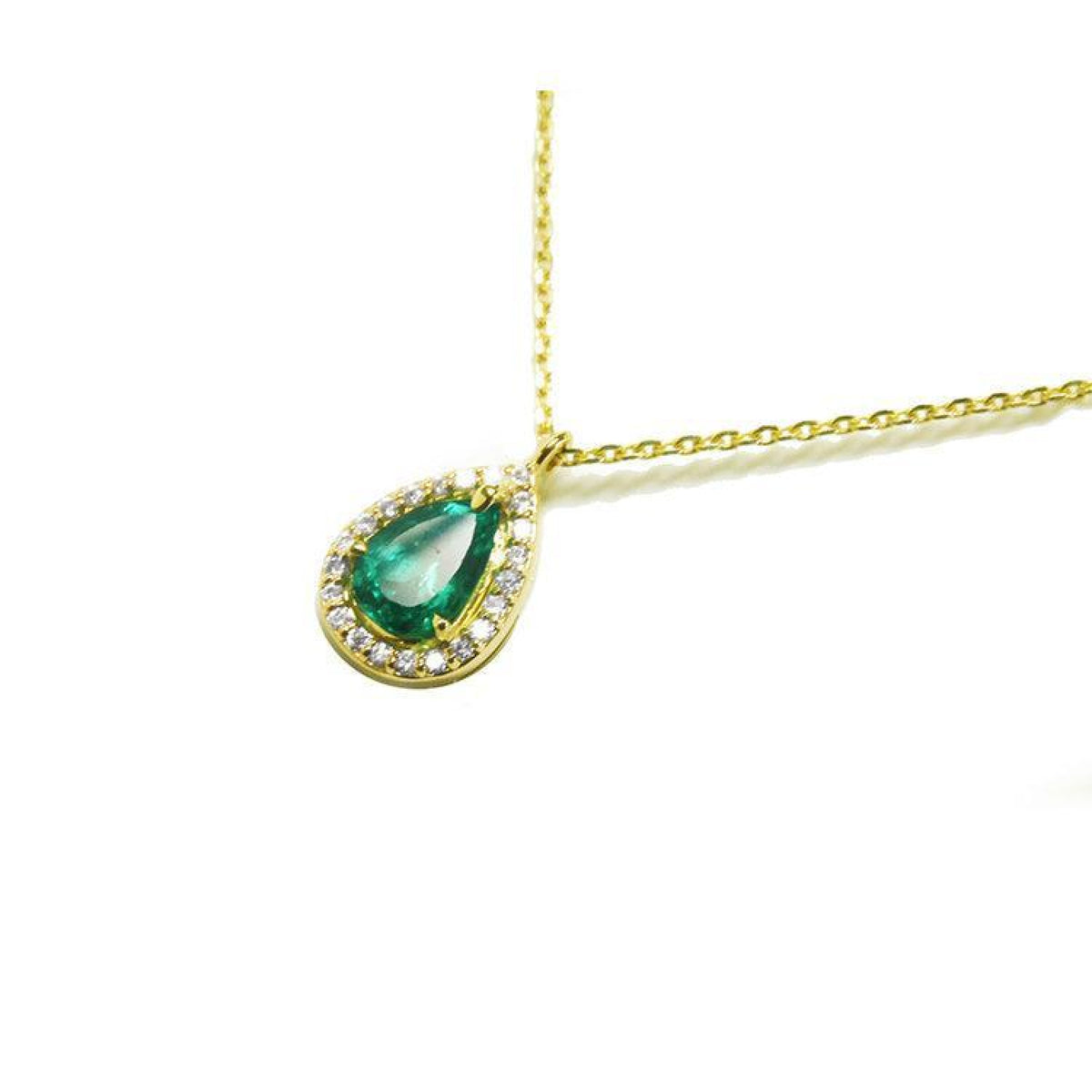 Pear-shaped natural emerald necklace with diamond halo in 14K yellow gold.