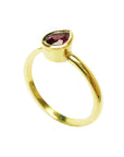 Teardrop natural ruby solitaire woman's ring 14K yellow gold, top-down shoulder shank profile view
