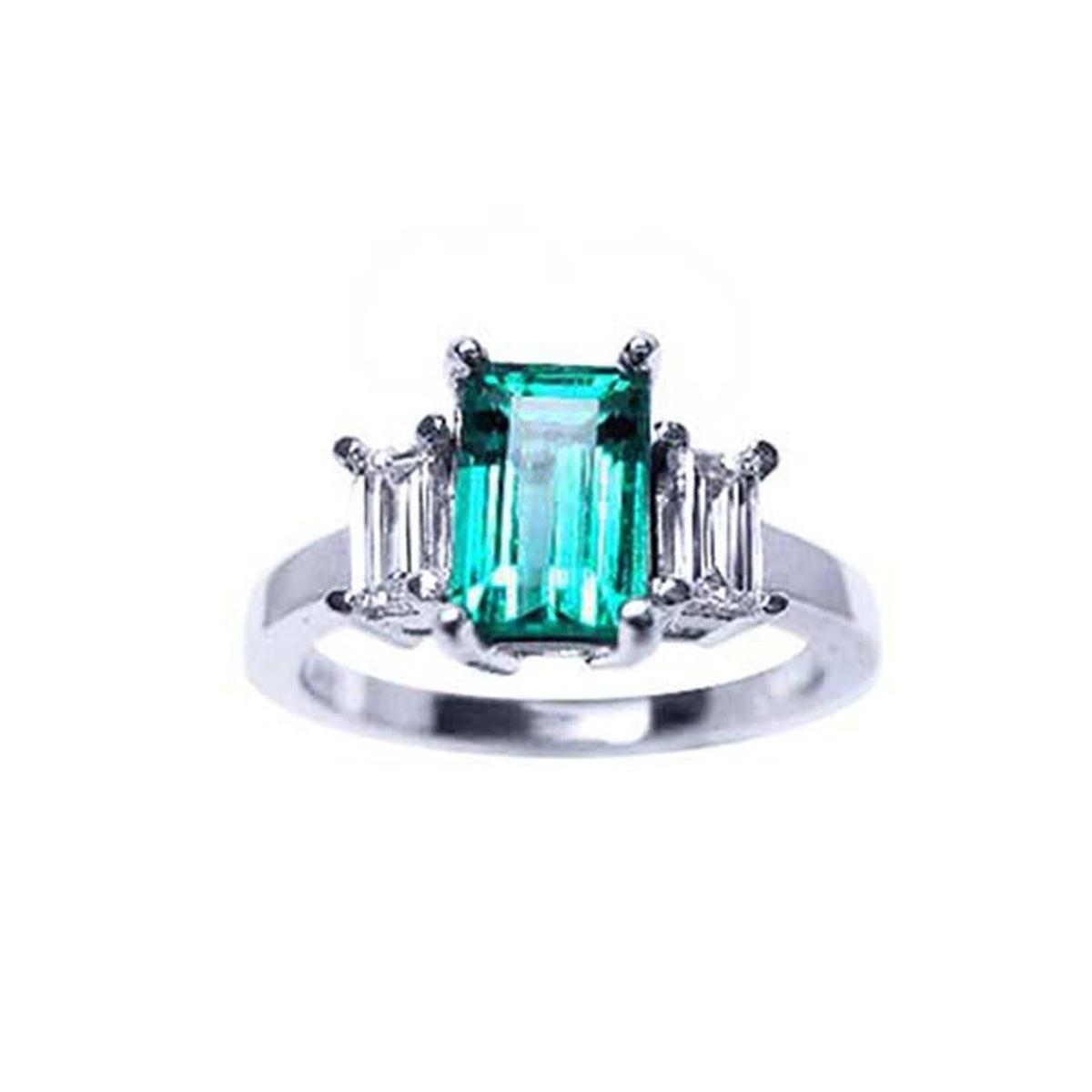 An emerald three stone ring side baguette diamonds, displaying a topside profile view. 