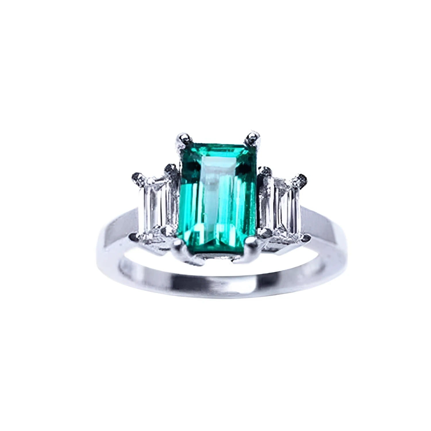 A colombian emerald three stone ring with side baguette natural diamonds, crafted in 18 white gold.