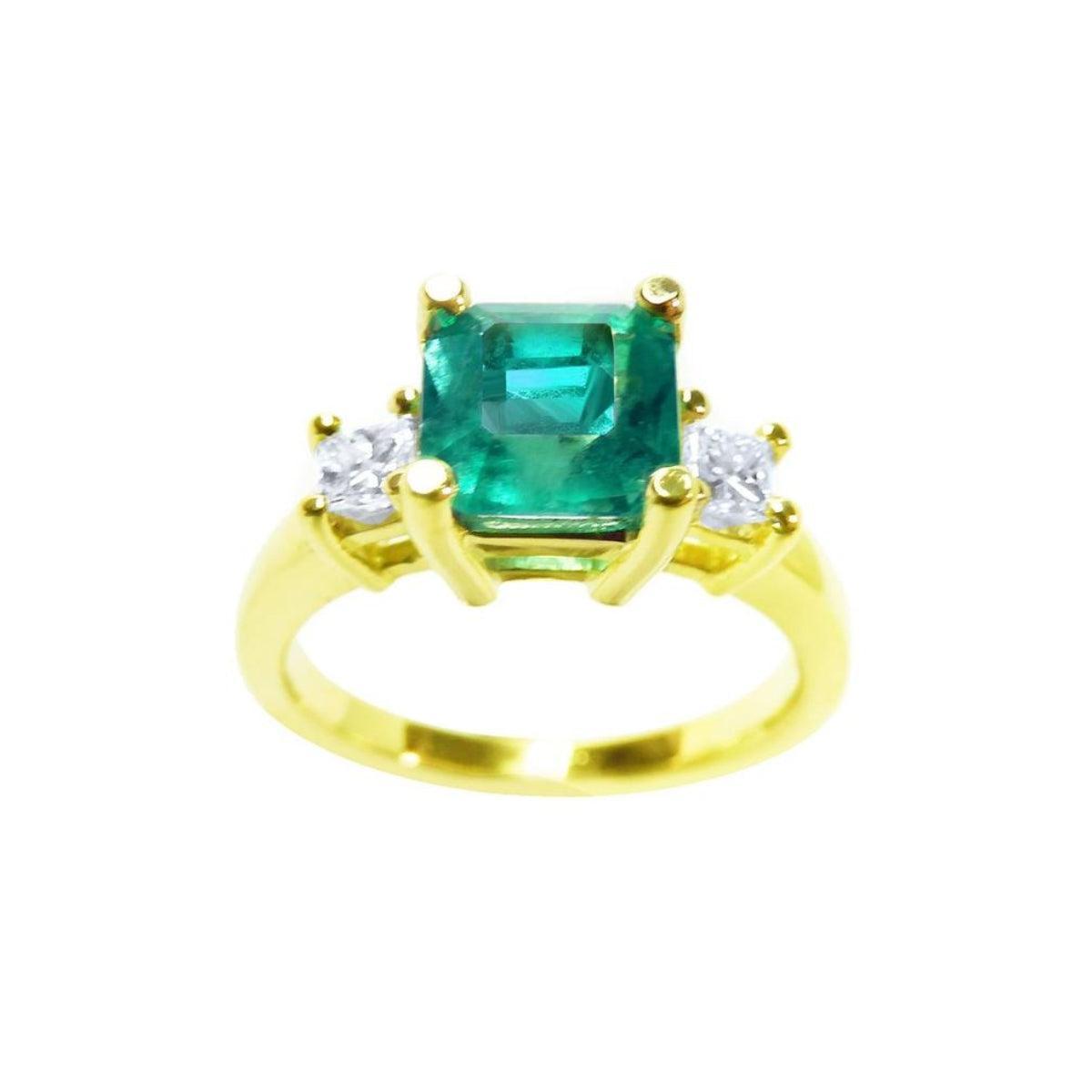 This Emerald-cut three stone emerald ring is showing the top square emerald and side diamonds profile.