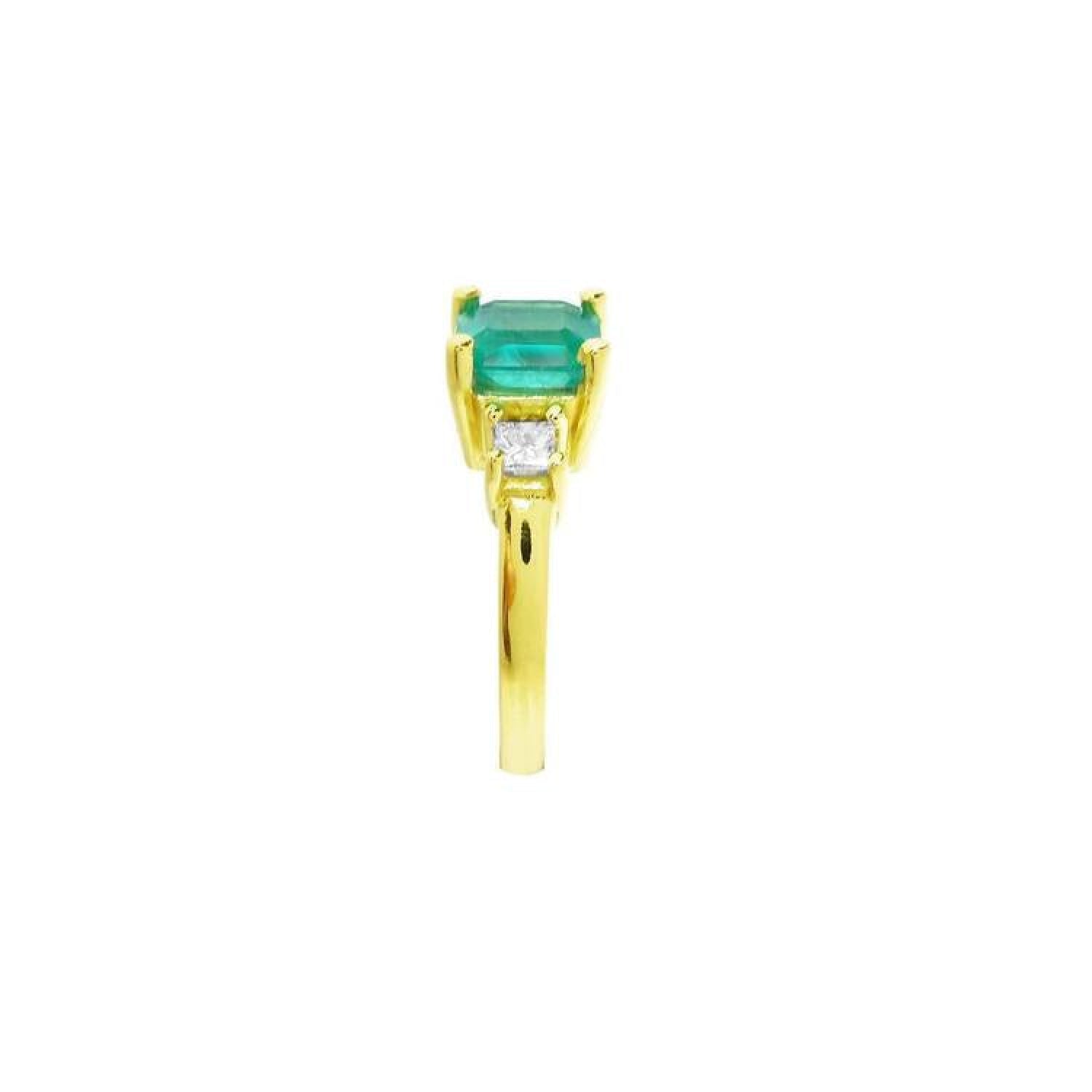 18K yellow gold three-stone ring with a square emerald and princess-cut side diamonds.