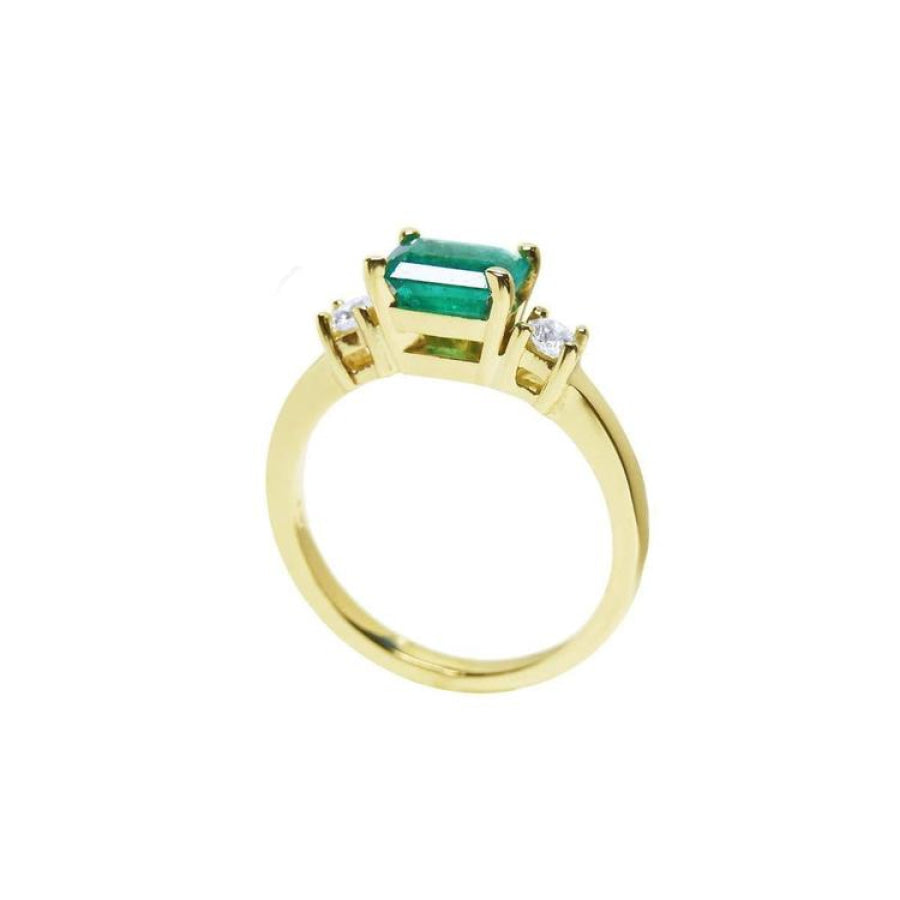 1.01 ct rectangular emerald ring with natural diamond side accents in 14K yellow gold.