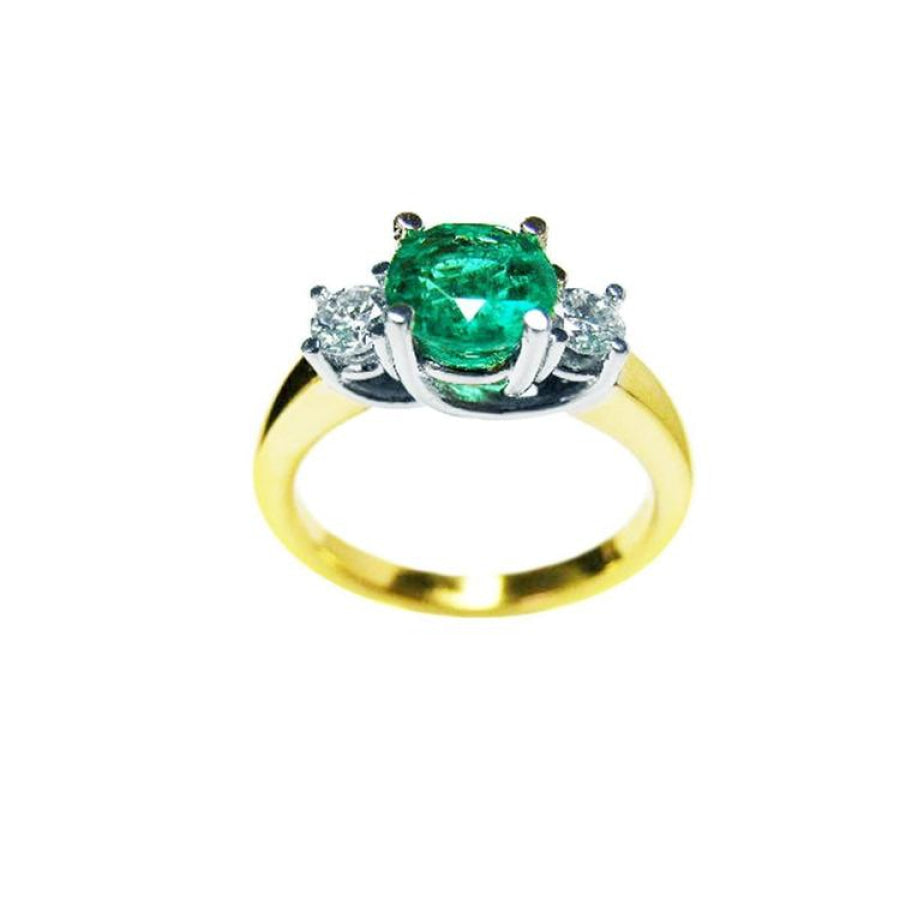 1.12 ct. round cut three stone emerald and diamond ring in 14k white and yellow gold.