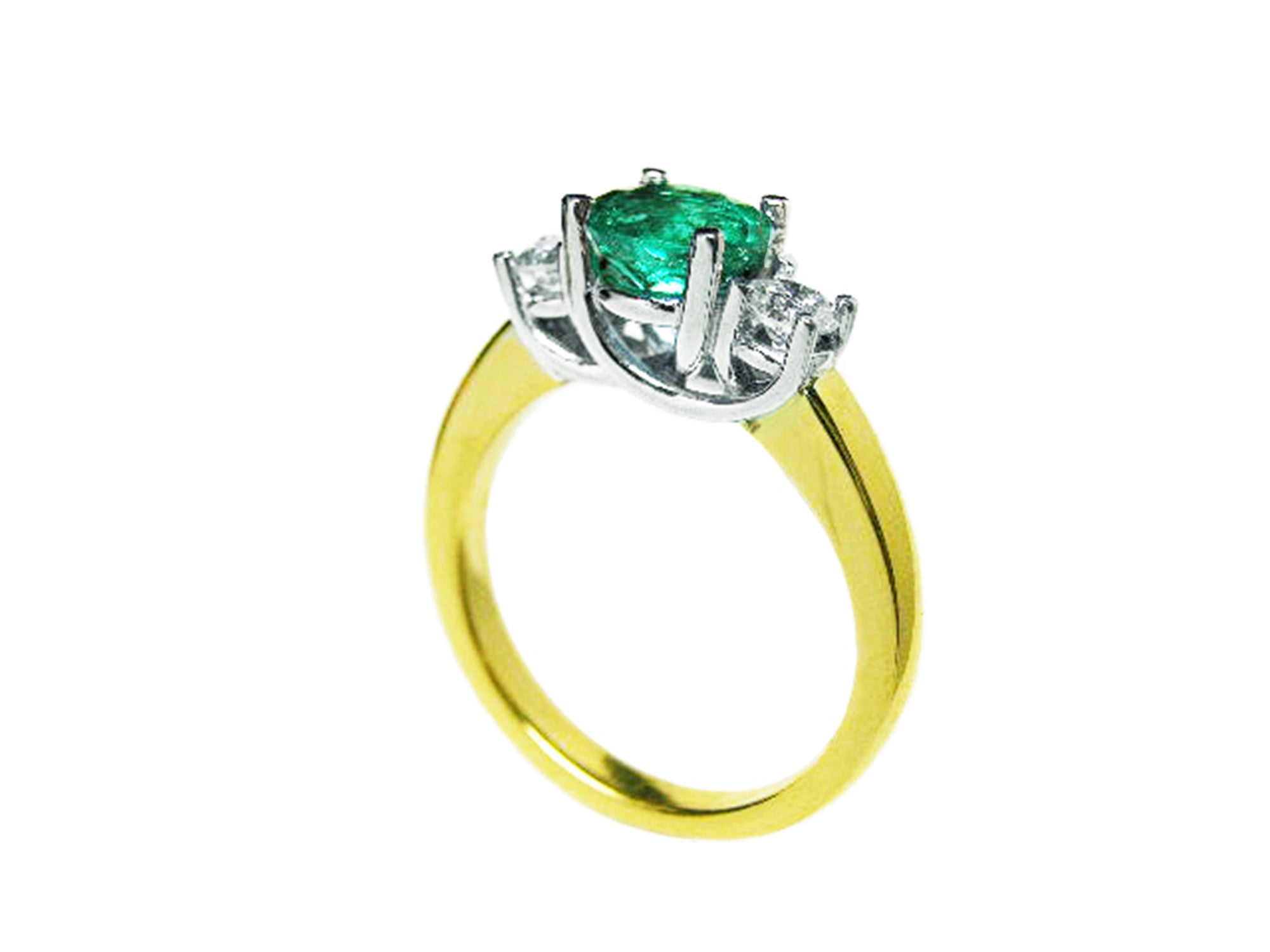 A 14k yellow gold emerald three stone ring and diamond accents on a white background.
