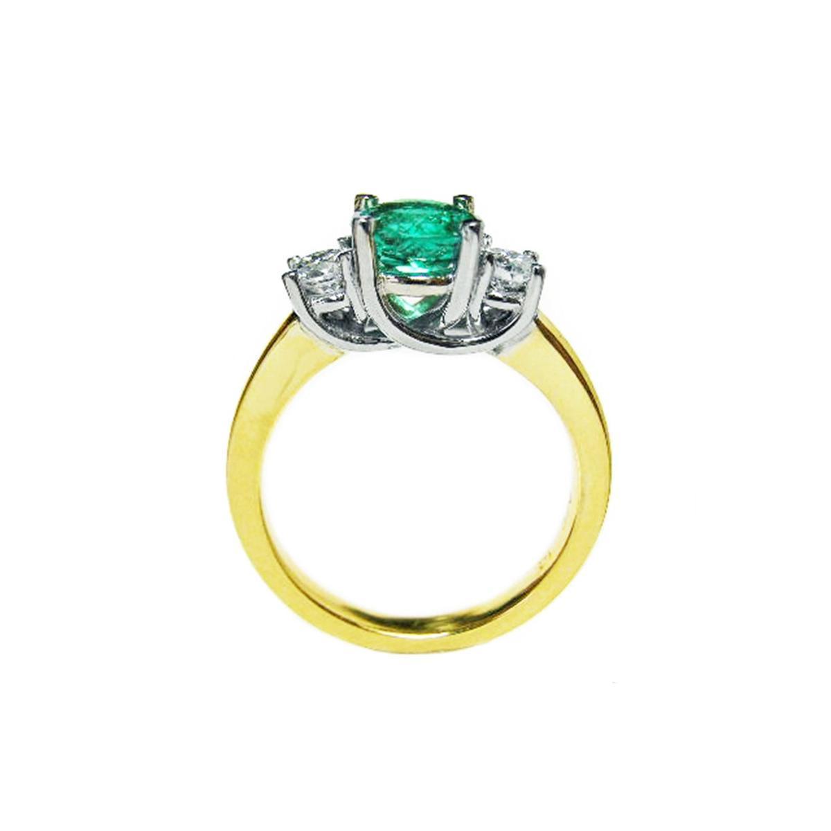 Lucida style emerald three stone ring and diamond accents on a white background.