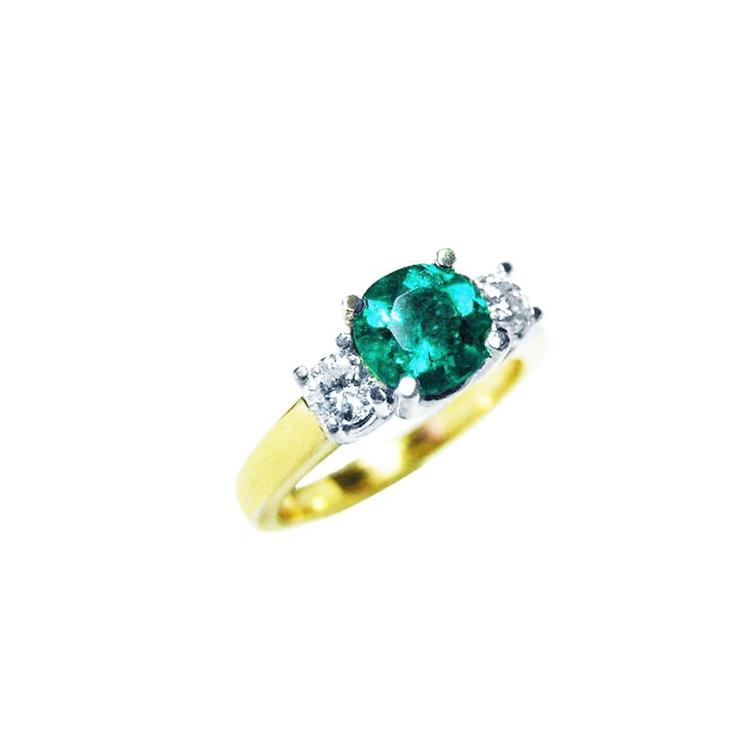 1.12 ct. round cut three-stone emerald and diamond ring in 14k white and yellow gold.