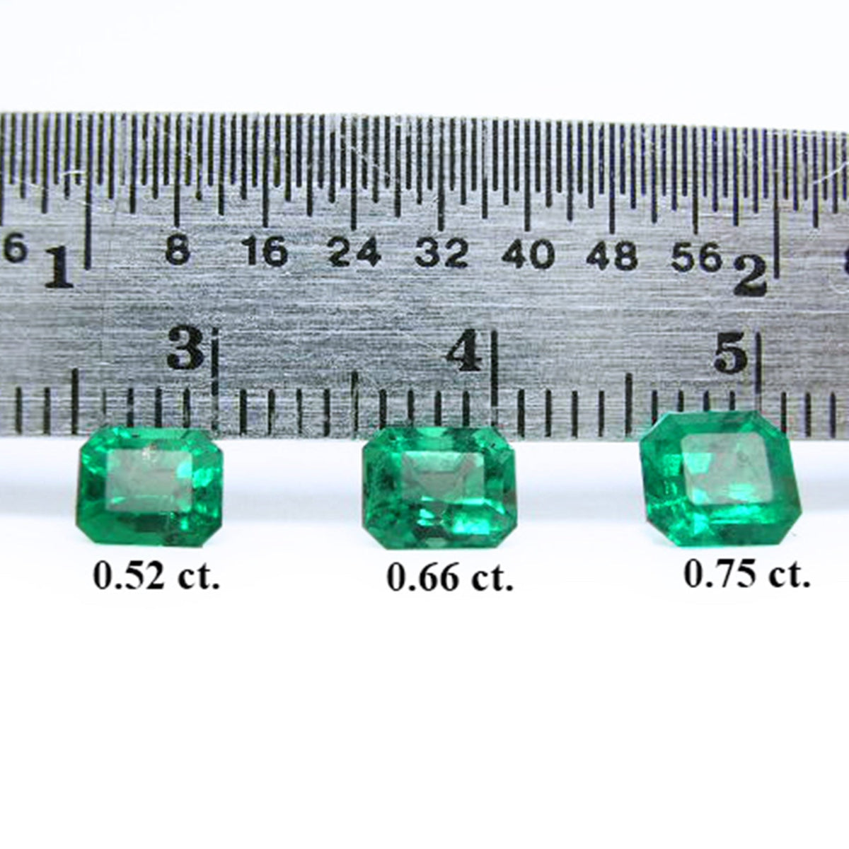 Three stone set emeralds