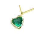 Tilted heart emerald necklace with halo diamonds in 18K yellow gold.