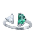 This negative space Toi et Moi ring features a half-moon-shaped natural Colombian emerald and a trillion-cut diamond.