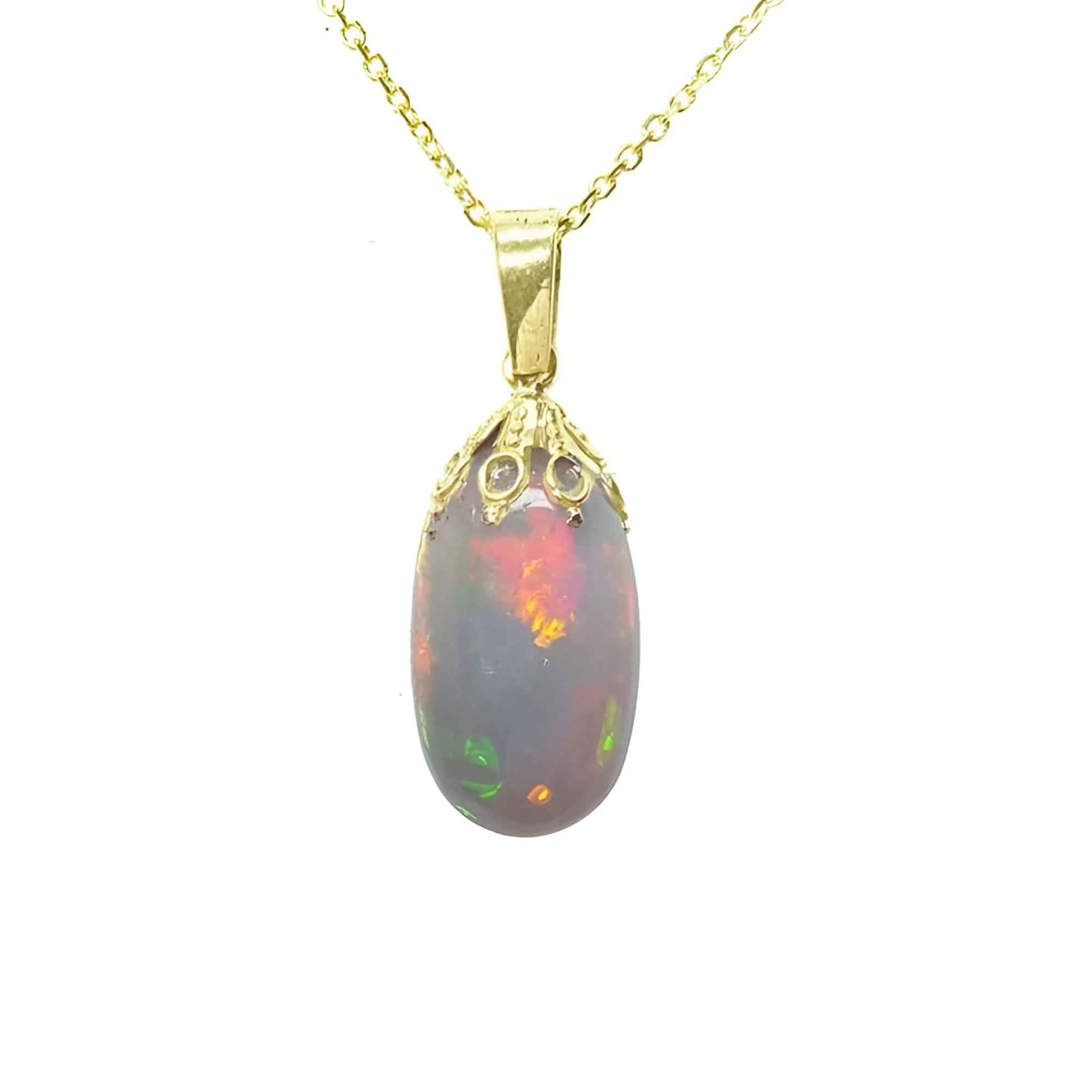 Ethiopian Welo opal pendant with vibrant red fire, set in 14k yellow gold on a delicate chain.