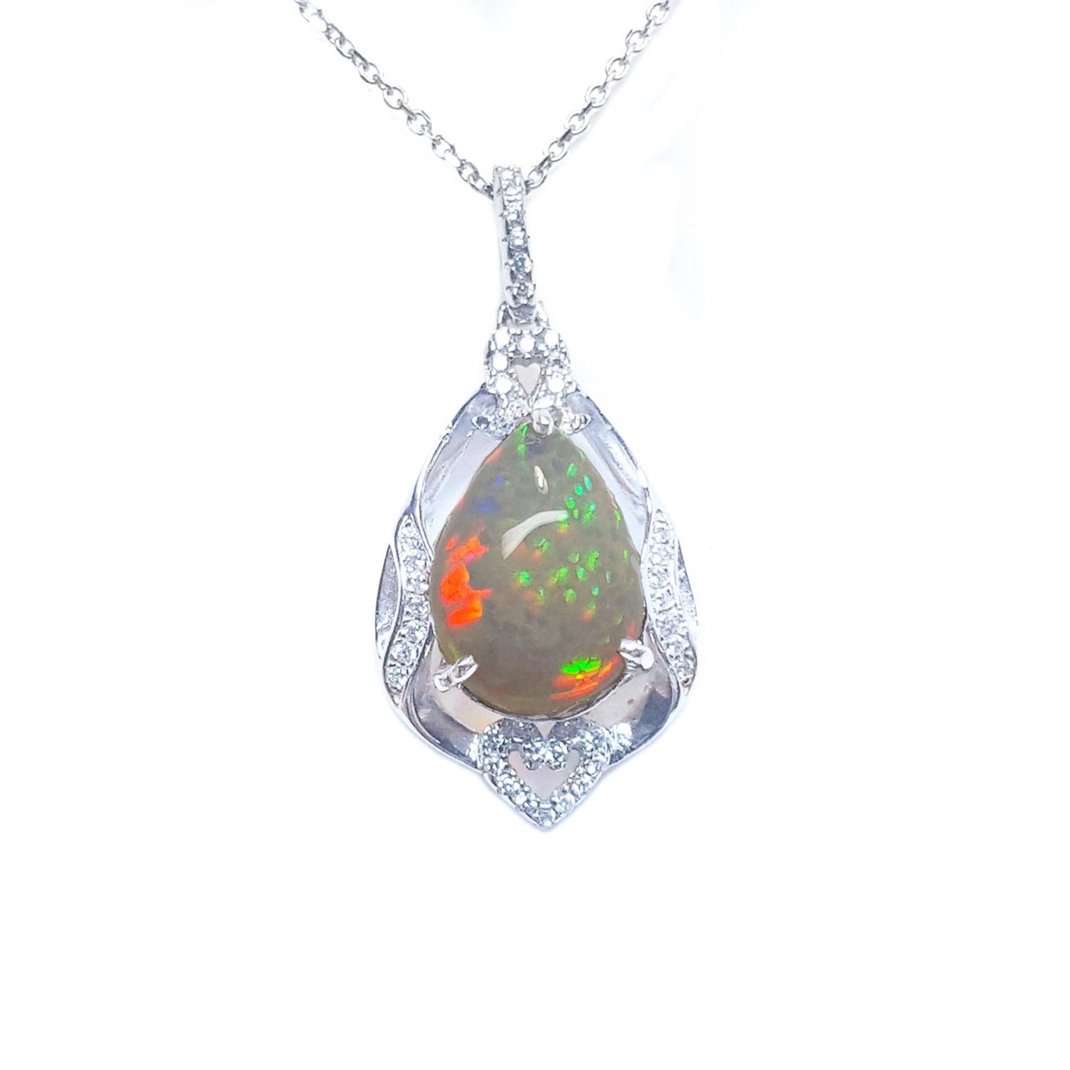Opal silver pendant necklace on a topside view and white background.