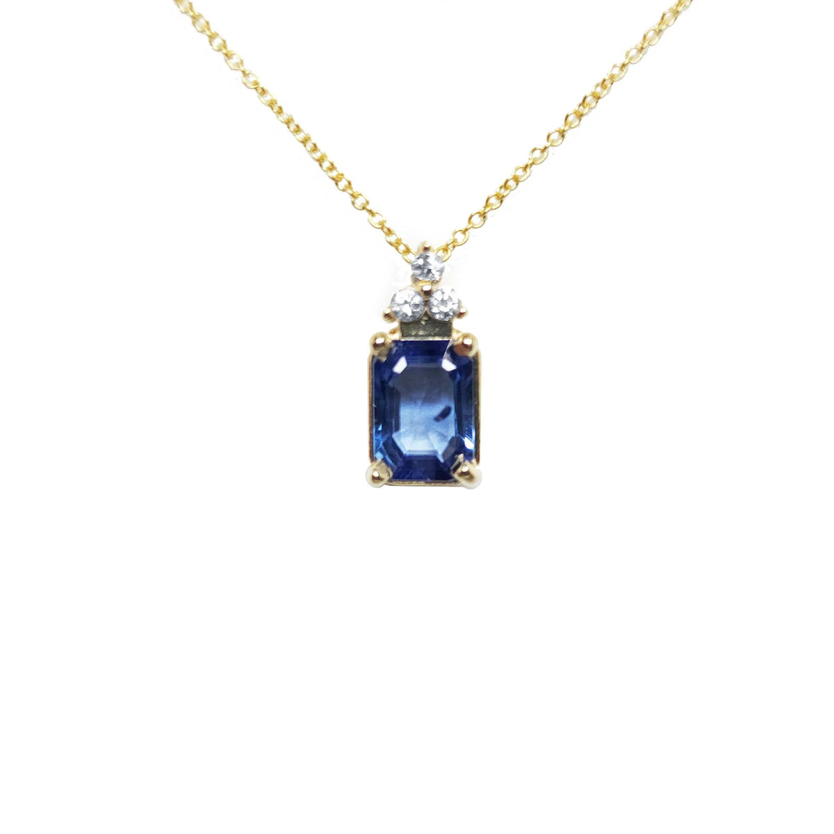 Natural blue sapphire pendant necklace and diamonds in 14k yellow gold topside view.