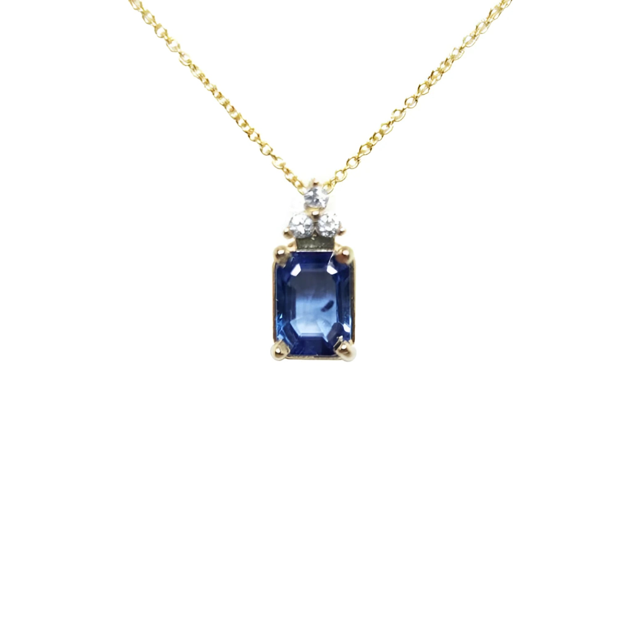 14k gold necklace with an emerald-cut blue sapphire pendant and three accent diamonds.