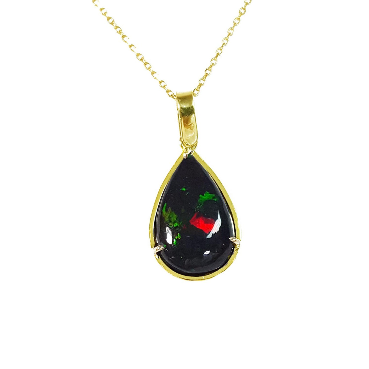 Teardrop-shaped Wello black opal pendant on a gold chain on topside view against a white background