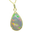 Opal pendant necklace with gold frame on a topside view position.