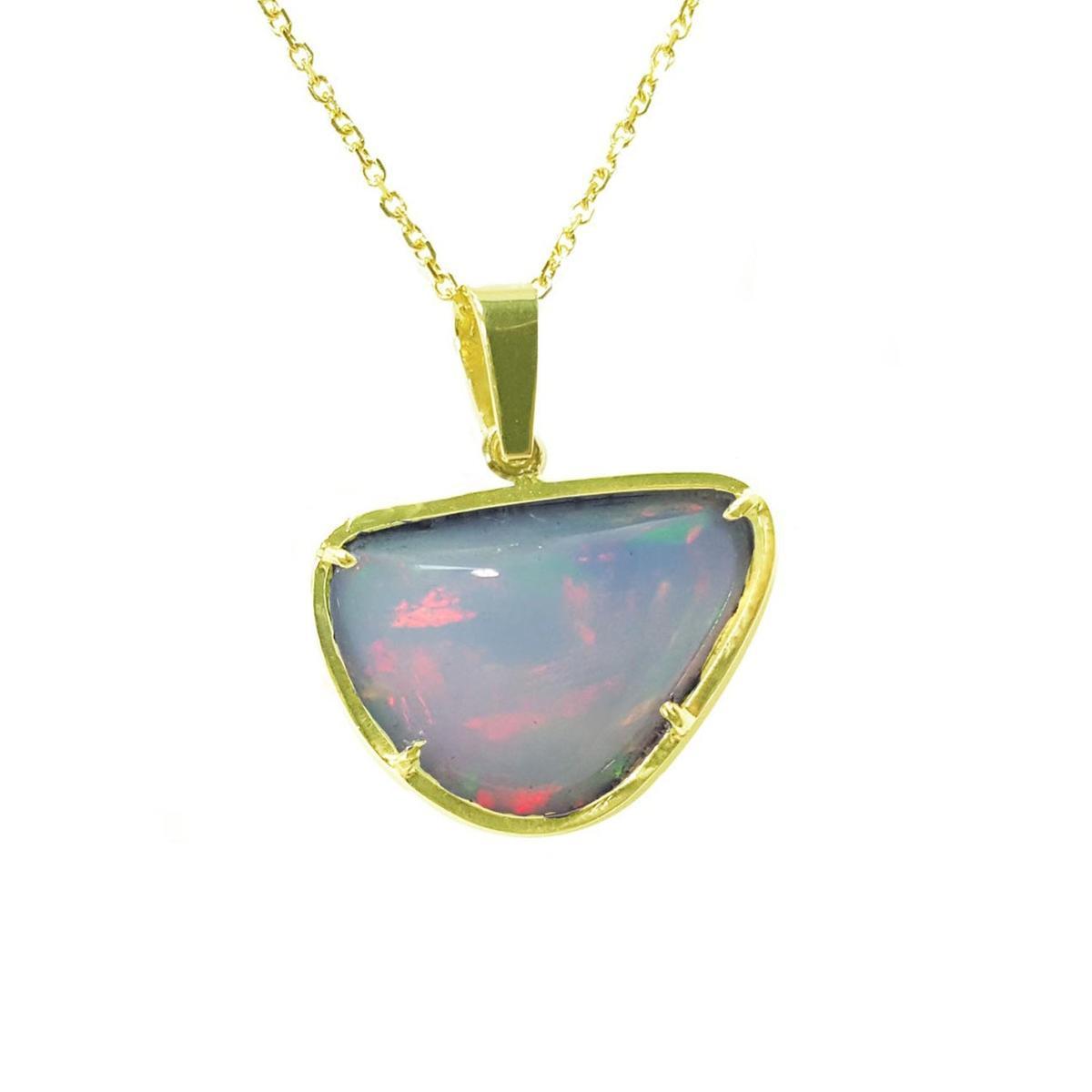 Opal pendant necklace with gold chain on a topside position white background